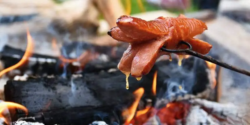 Hot Dog Over A Campfire Using Hotdog Roasting Sticks